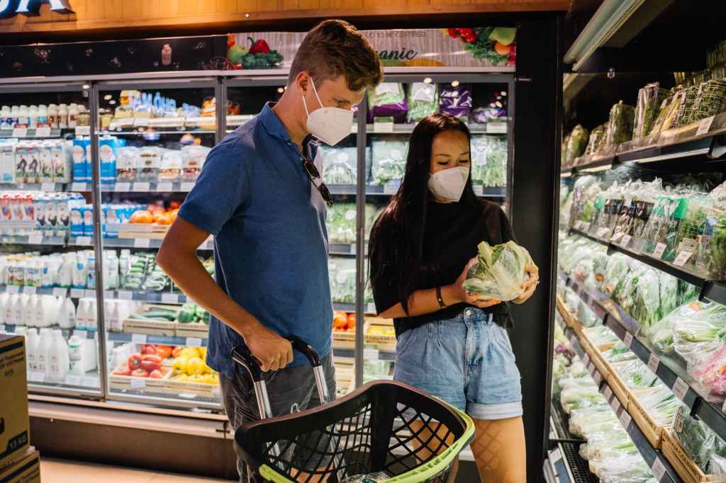 a couple buying vegetable inside a grocery store